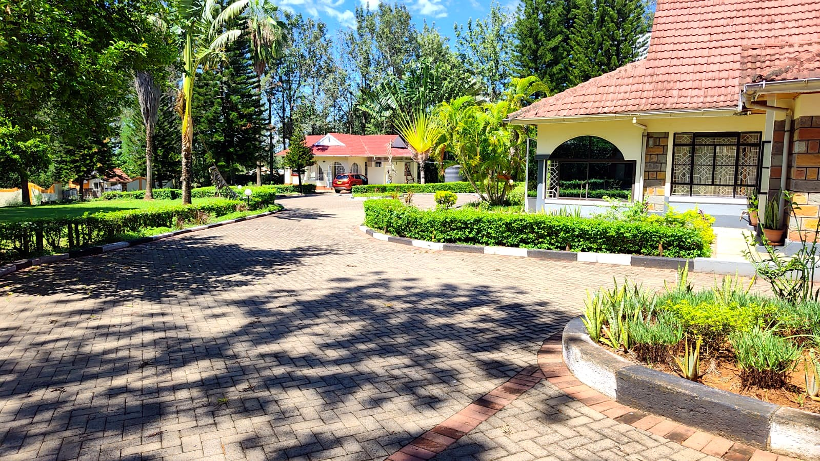 Paved driveway through the landscaped grounds at Kamito Lakeside Retreat